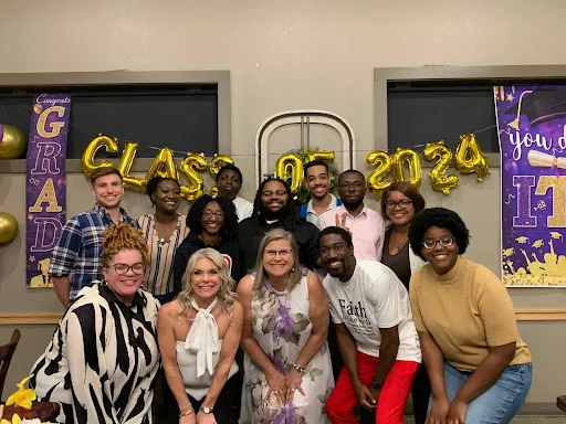 Seed 2 Harvest participants and mentors celebrating beneath Class of 2024 balloons.